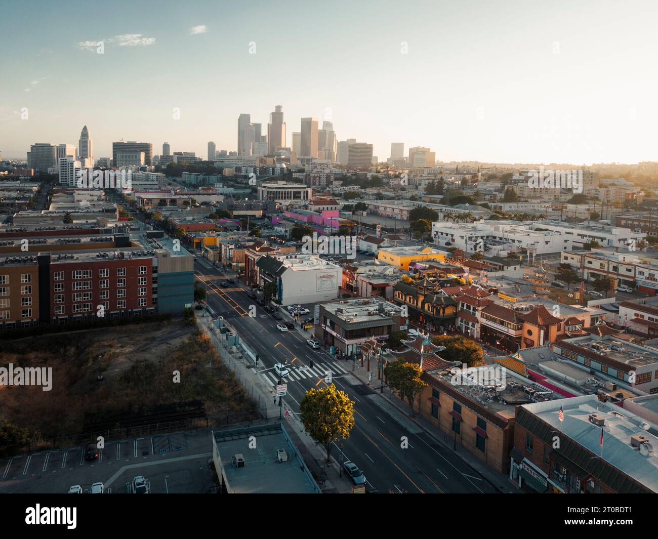Aerial view of a city skyline landscape during sunrise, with rays of 
