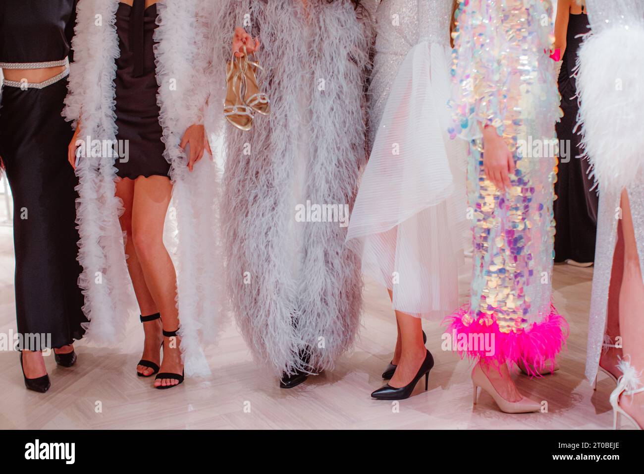 Fashion models on backstage dressed in a long Haute couture boudoir dresses outfits and high heels. Preparation before the fashion show Stock Photo