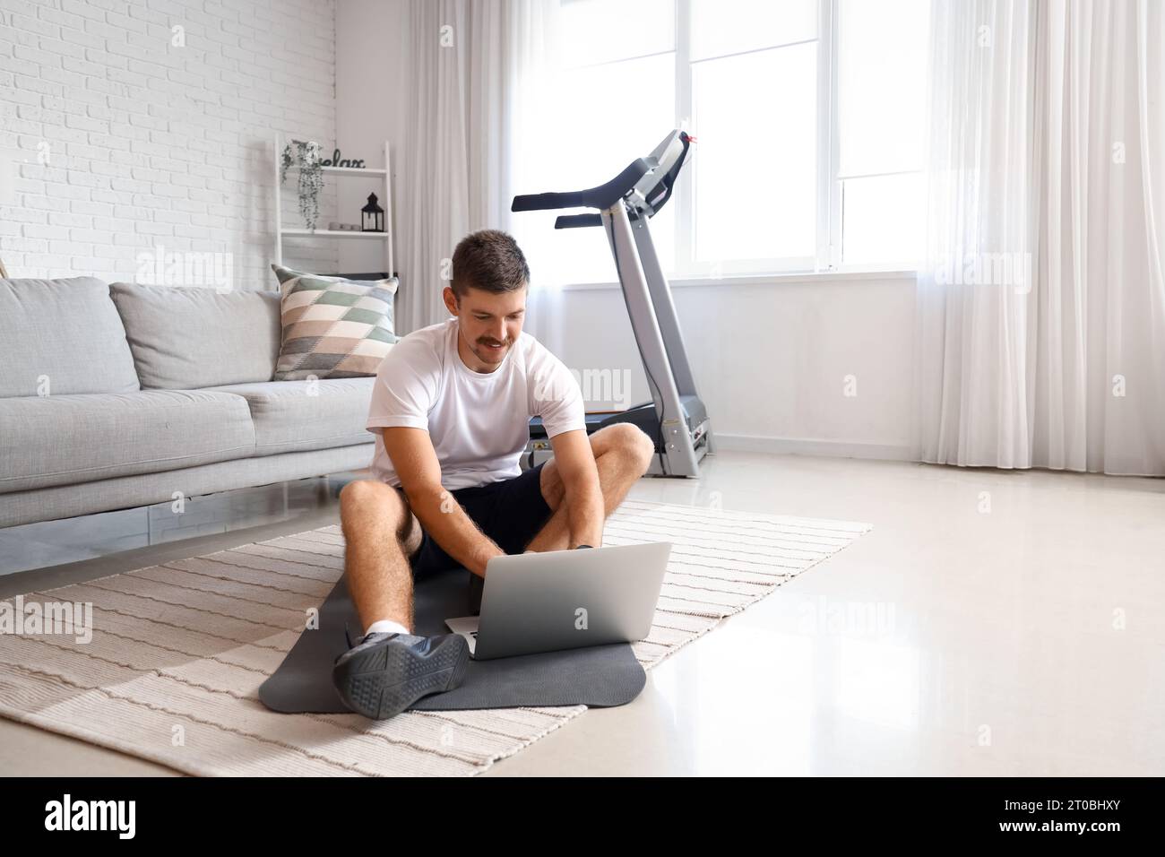 Sporty young man laptop hi-res stock photography and images - Alamy