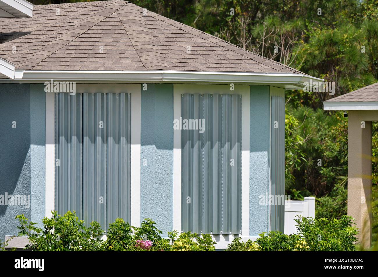 Steel storm shutters for hurricane protection of house windows. Protective measures before natural disaster in Florida. Stock Photo
