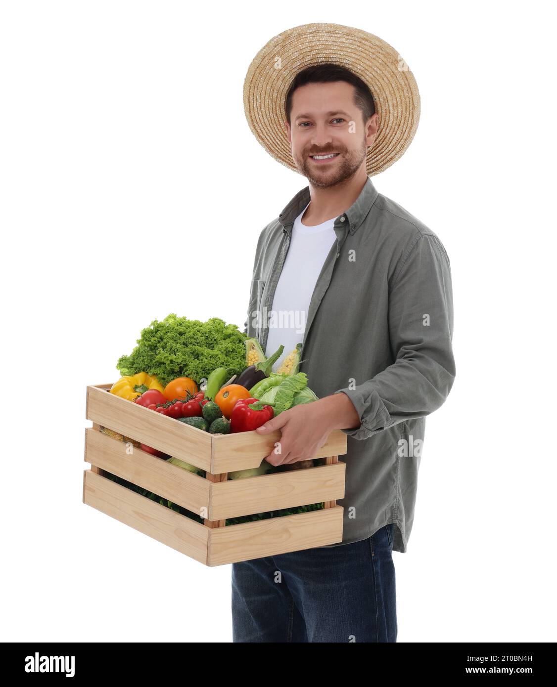 Harvesting season. Happy farmer holding wooden crate with vegetables on ...