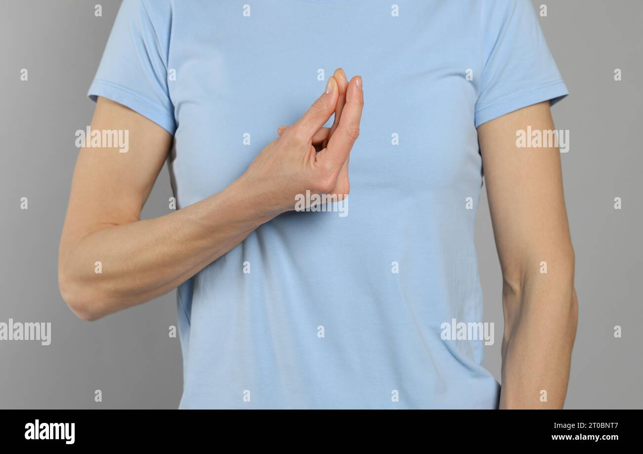 Woman snapping her fingers on light grey background, closeup. Bad habit Stock Photo Alamy