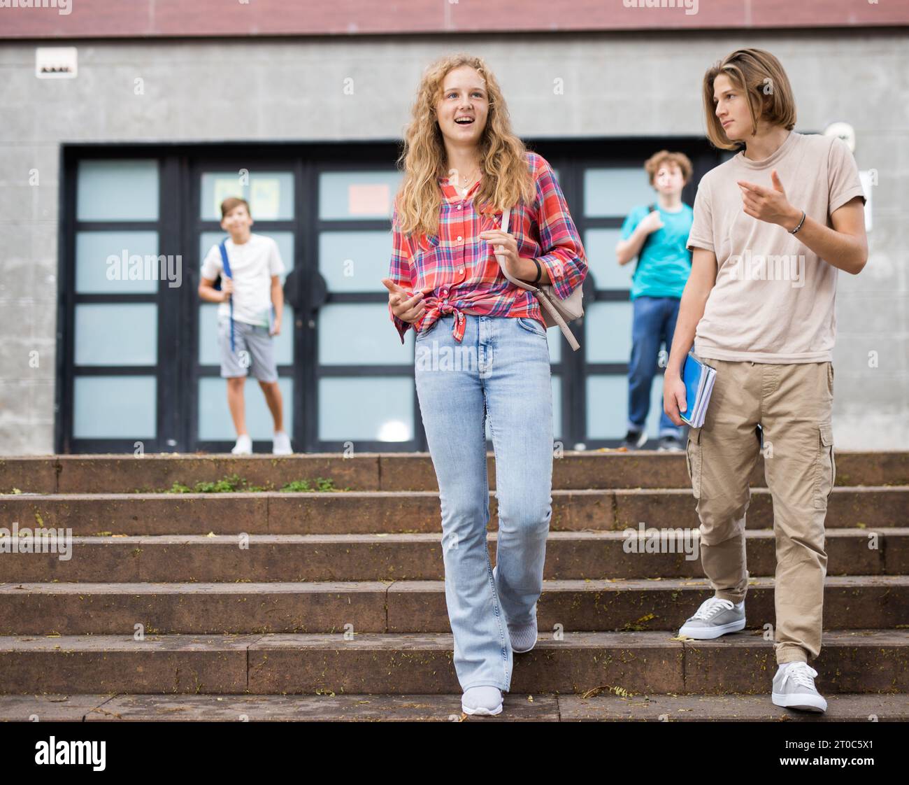 Teenager girl and boy going home after school Stock Photo - Alamy