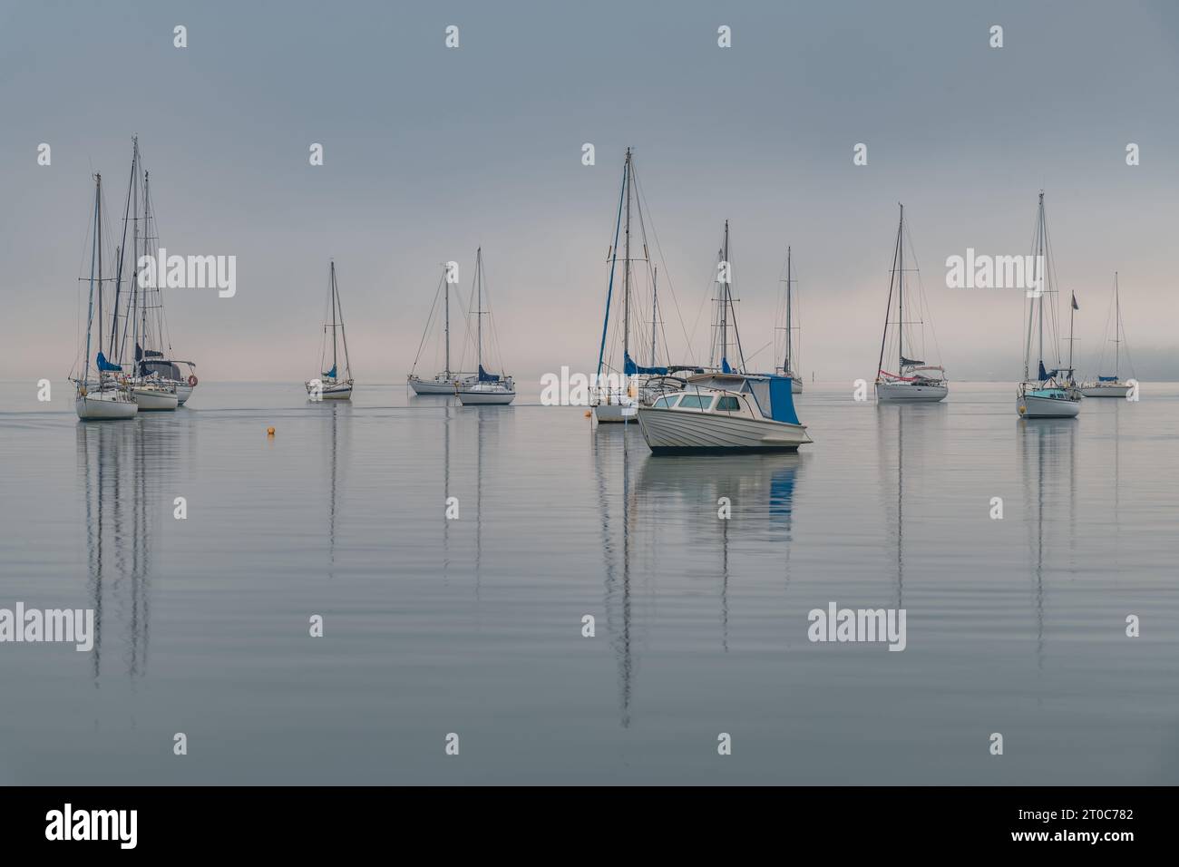 Foggy Sunrise with boats on Brisbane Water at Koolewong and Tascott on the Central Coast, NSW, Australia. Stock Photo