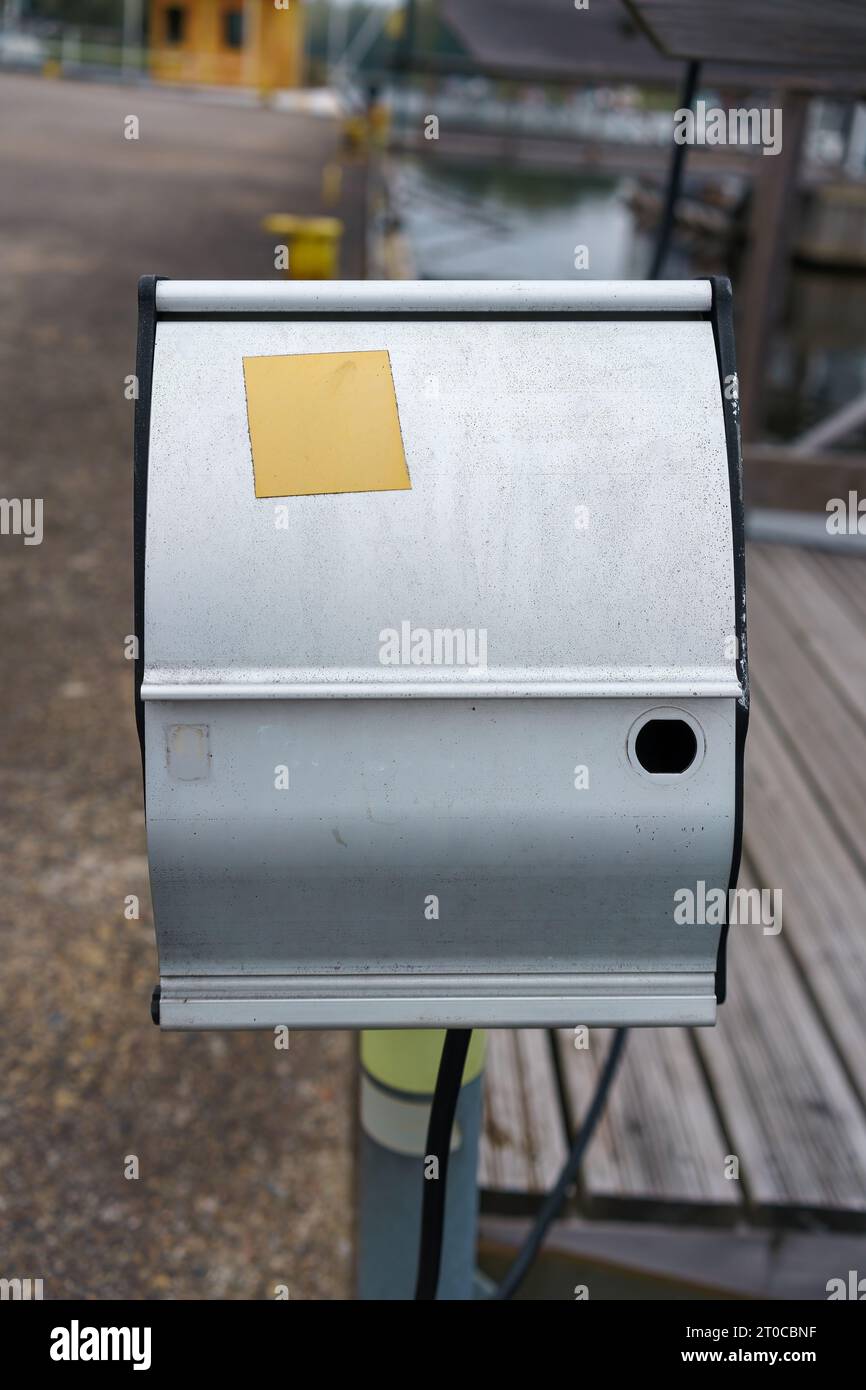 Power outlet box in the harbor with yellow empty sticker, Finland. Stock Photo