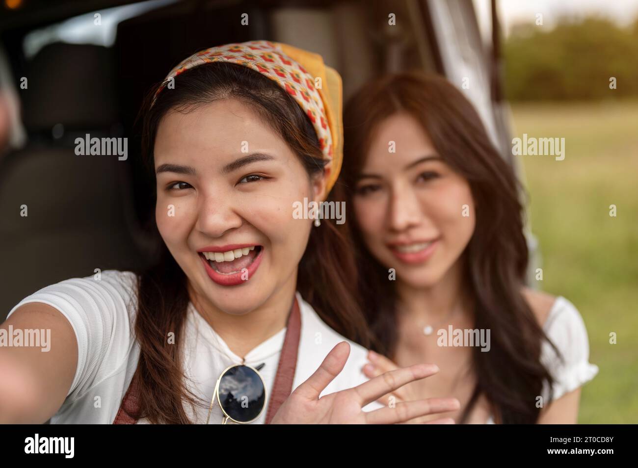 Two Carefree And Cheerful Young Asian Women Are Enjoying Their Road Two Carefree And Cheerful Young Asian Women Are Enjoying Their Road