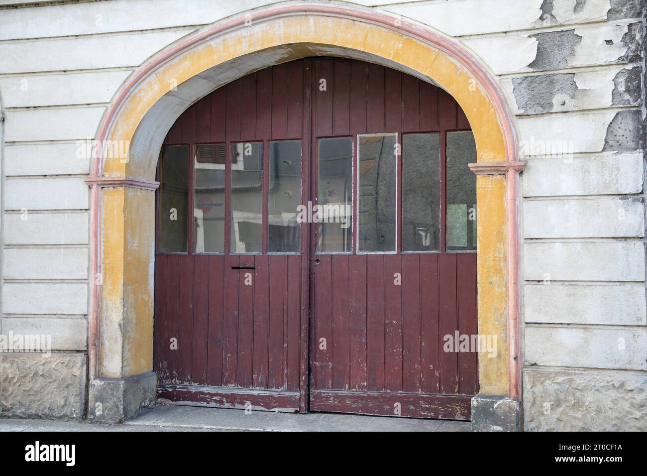 Dark wooden old door with windows and arch ancient house building ...