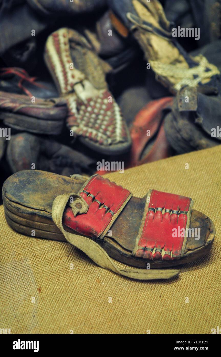 Sandals and shoes of victims collected/confiscated by SS before extermination, on display at the museum in Auschwitz Birkenau, Poland, October 2012 Stock Photo