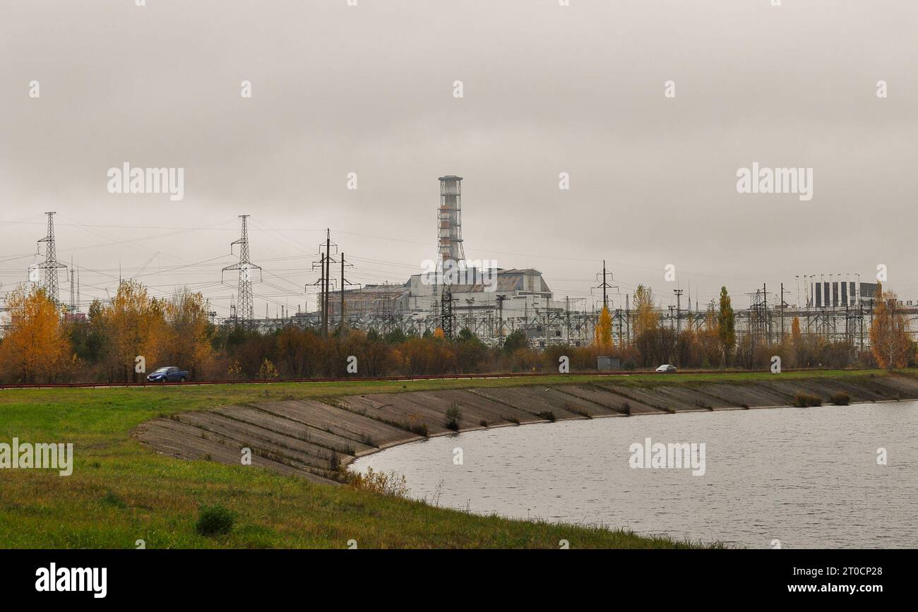 View of reactors #3 and #4 of Chernobyl and Pripyat River, Ukraine, where the explosion happened, #4 covered in the old sarcophagus, October 2012. Stock Photo