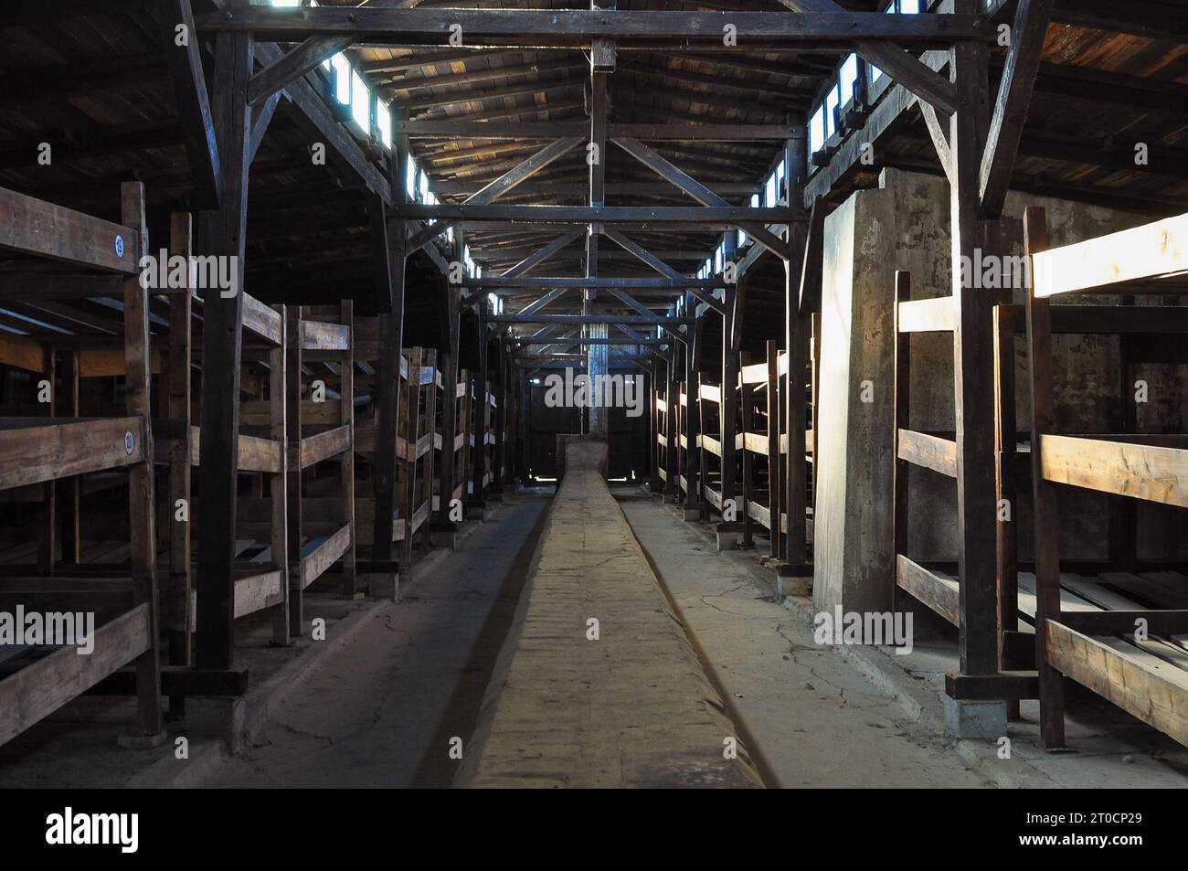 Inside a dormitory for prisoners (at least a few hundred in each dorm) at Auschwitz Birkenau Concentration Camp, Poland. October 2012 Stock Photo