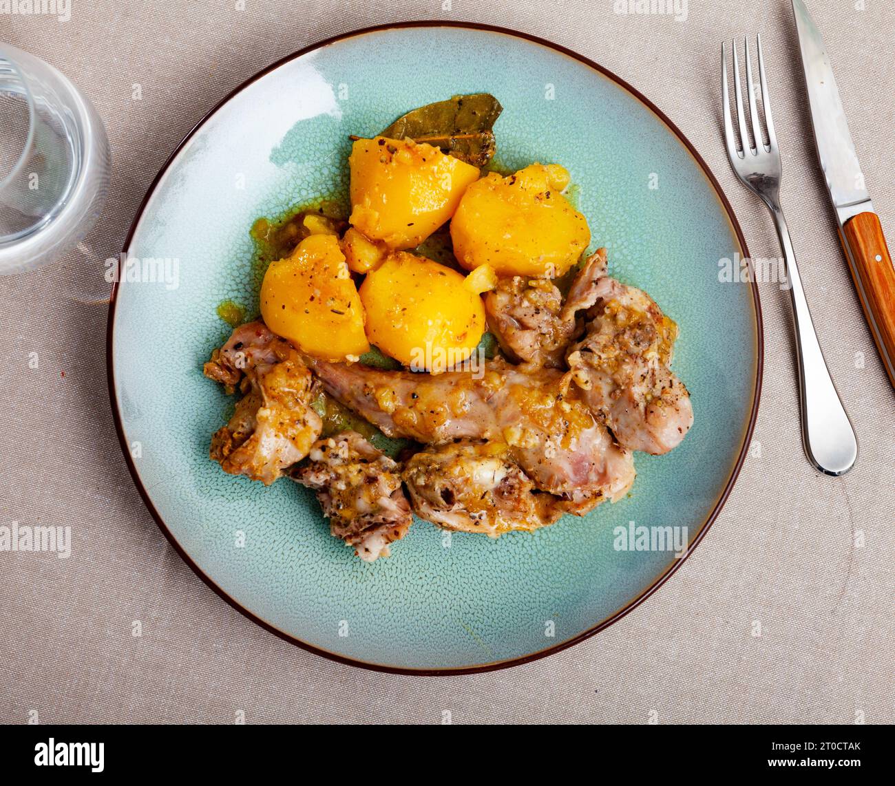 Braised rabbit served with potato garnish Stock Photo