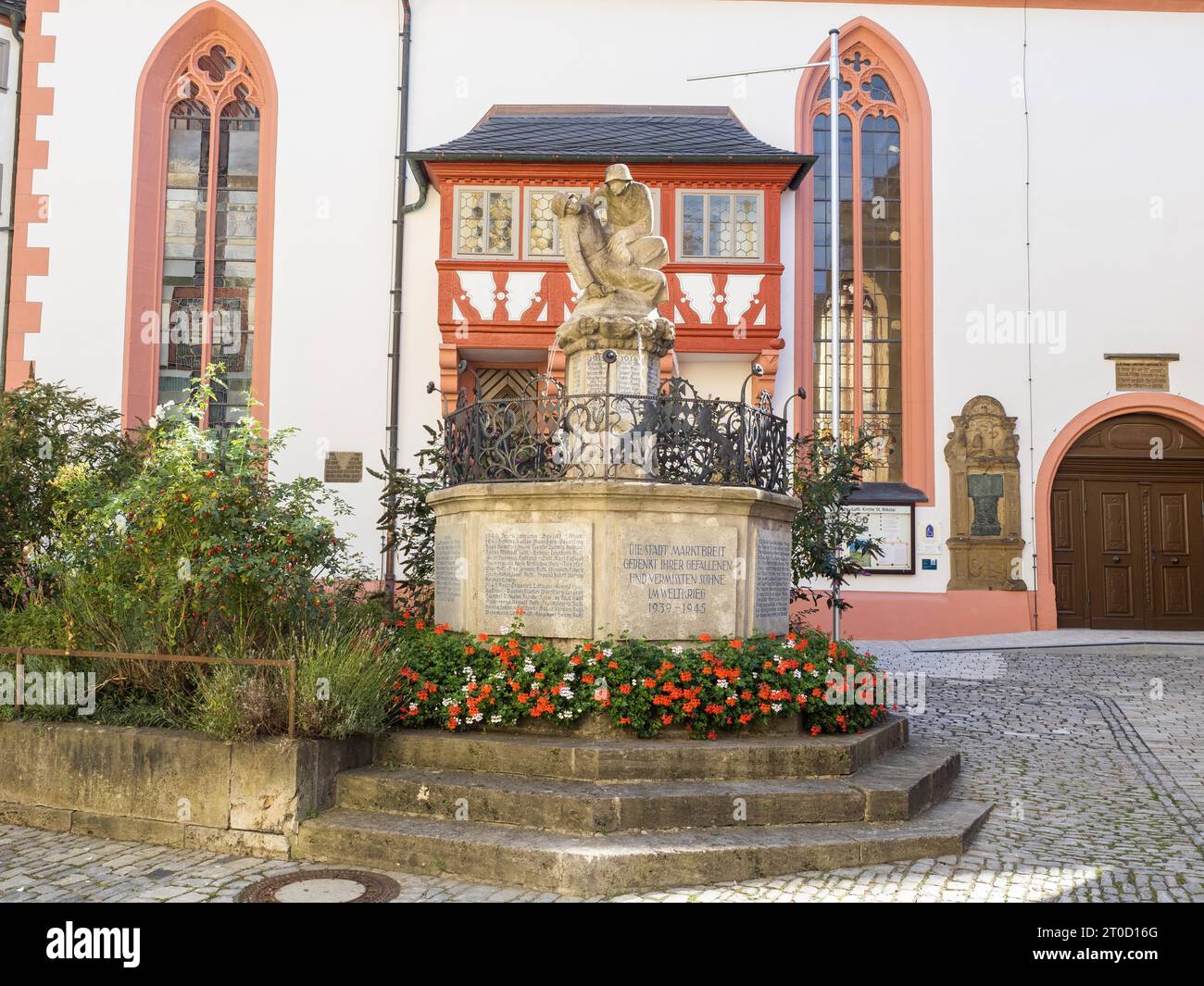 Fountain with monument for fallen soldiers, near the church of St. Nikolai, town of Marktbreit, district of Kitzingen, Lower Franconia, Bavaria Stock Photo