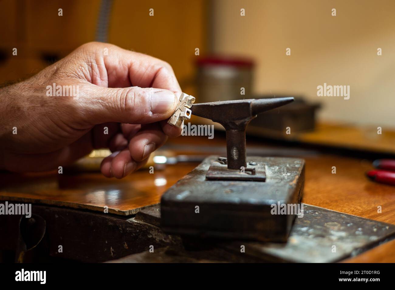 Goldsmith creating and repairing in his crafting gold jewelry