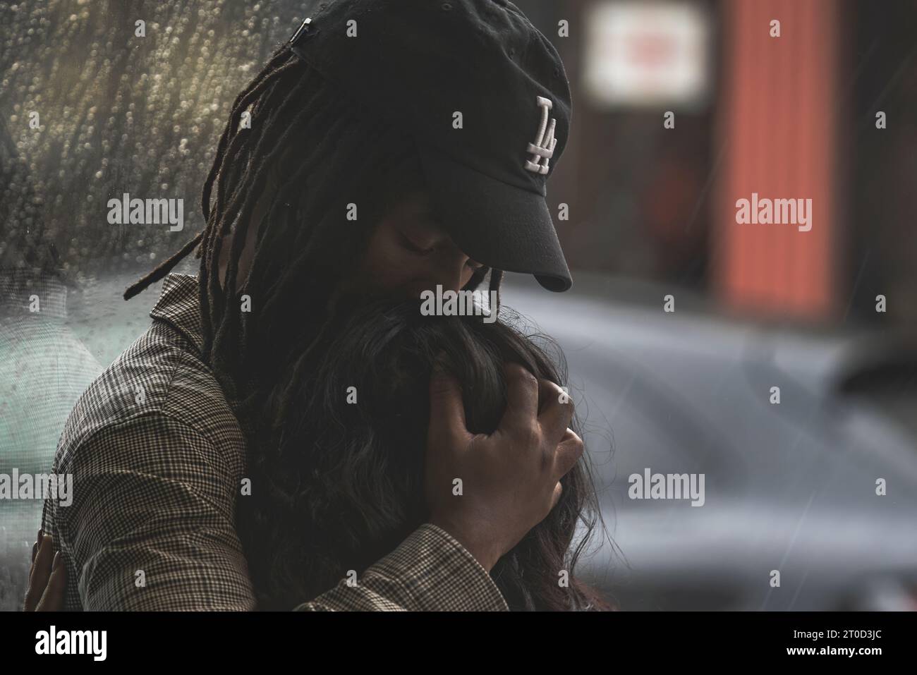 Couple embracing while waiting for rain Stock Photo