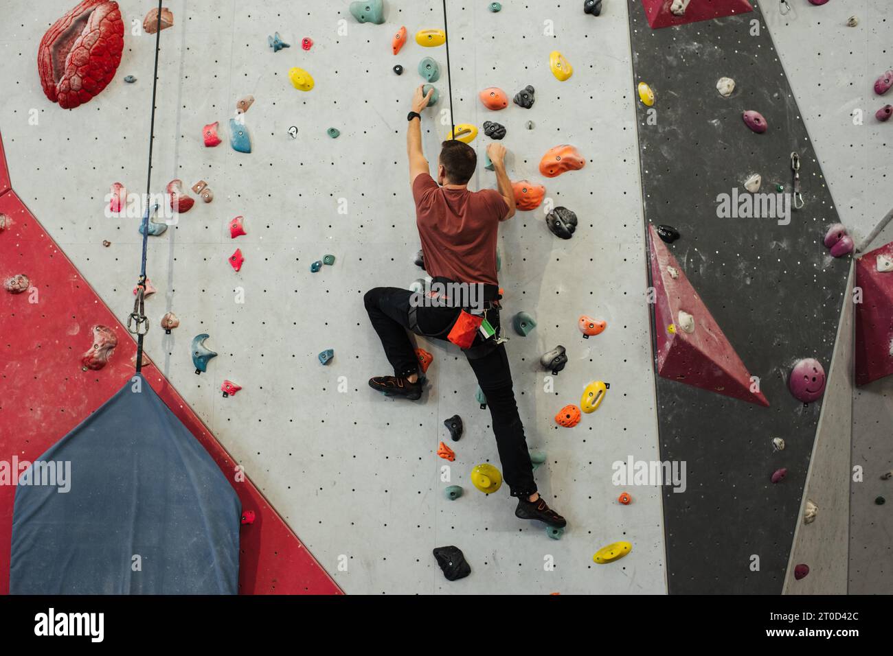 man climbing an auto belay wall at a gym Stock Photo Alamy