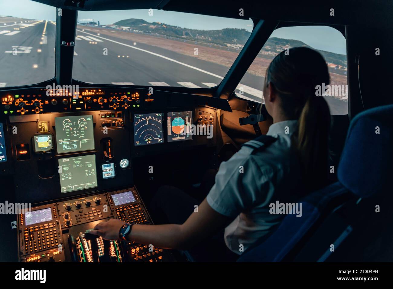 Female student pilot at the cockpit of an airliner Stock Photo