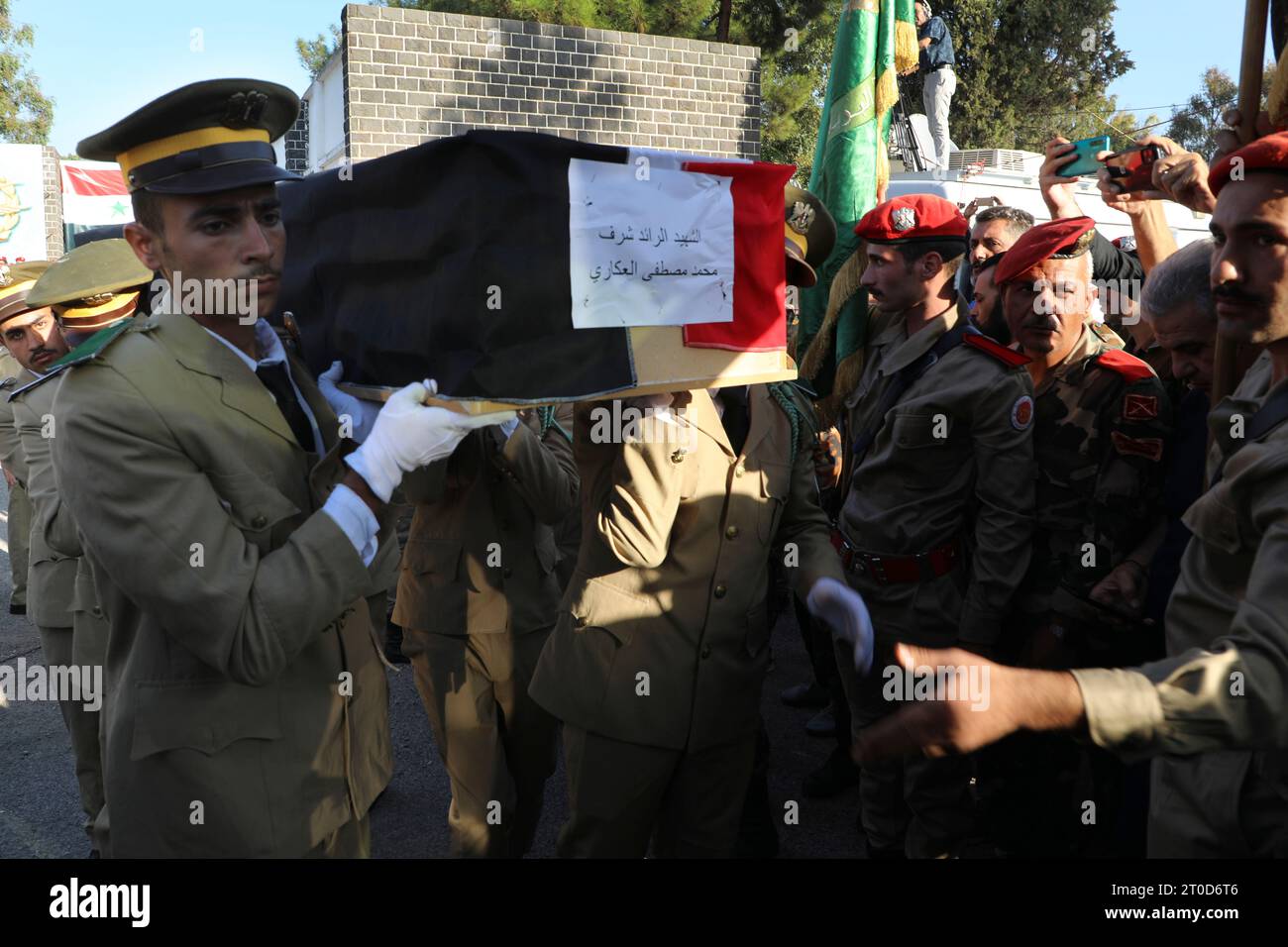 Syrian student officers carry the coffin of Major Mohammed Akkari who ...