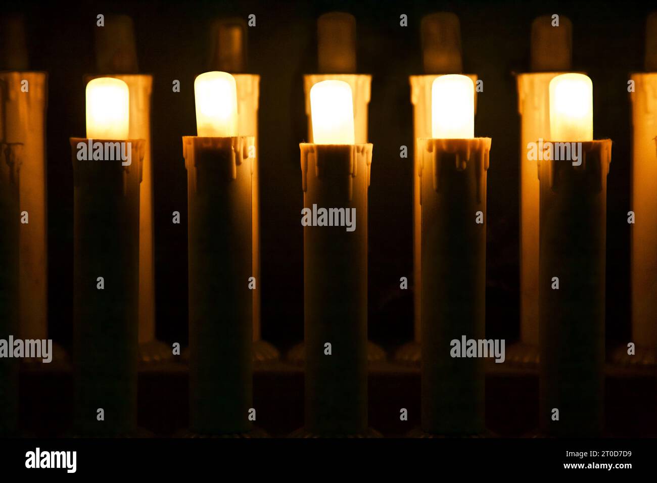 Electric candles in the dark seen up close Stock Photo