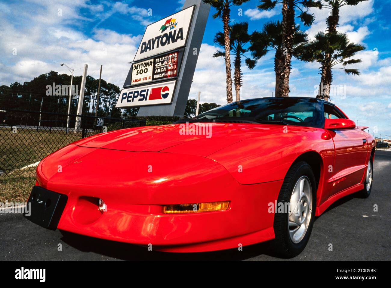 Red Pontiac Firebird Trans Am 1995 series 3 model parked on the sand at Daytona Beach, Florida, USA Stock Photo