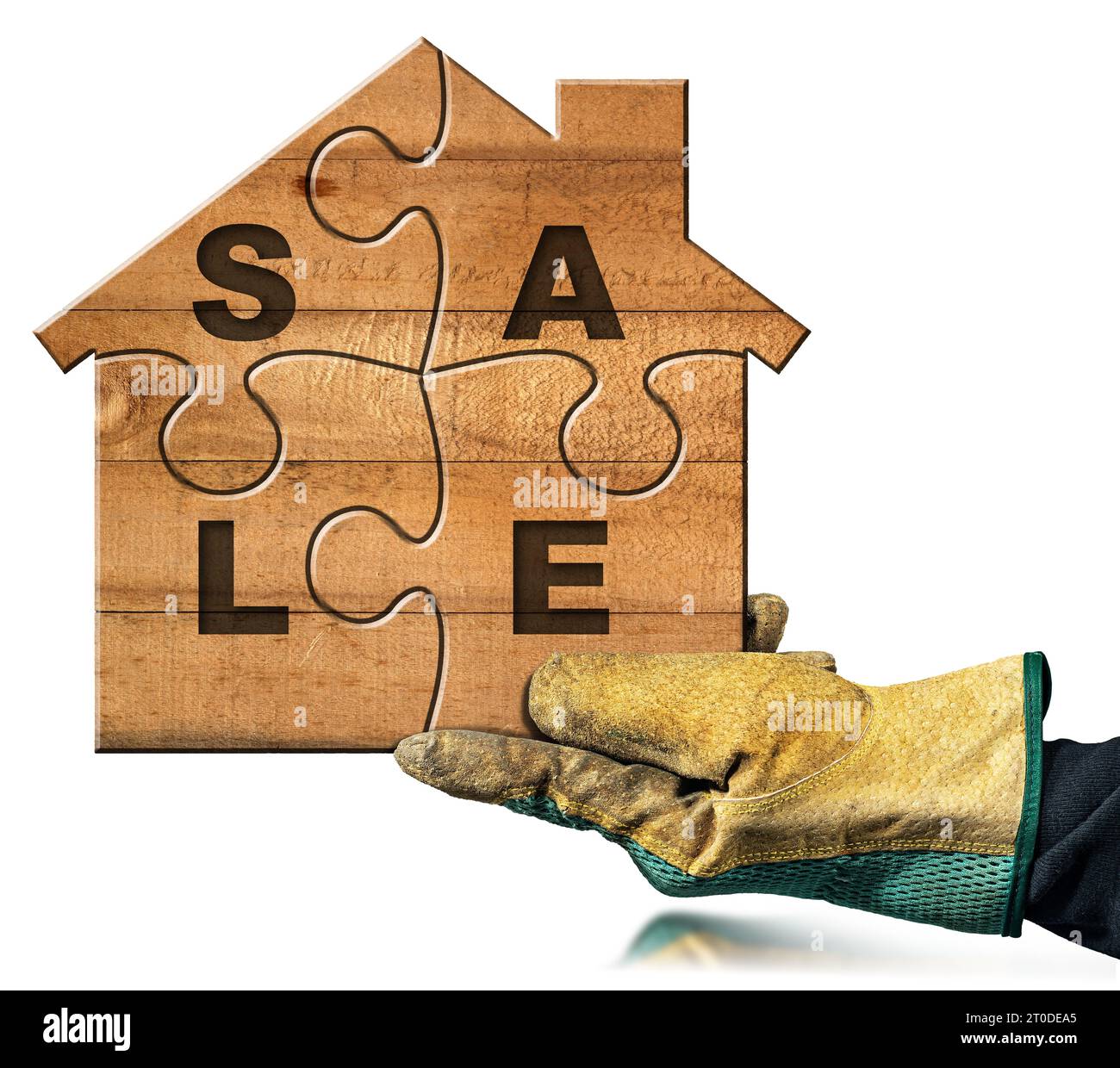 Hand with protective work glove holding a small wooden house formed