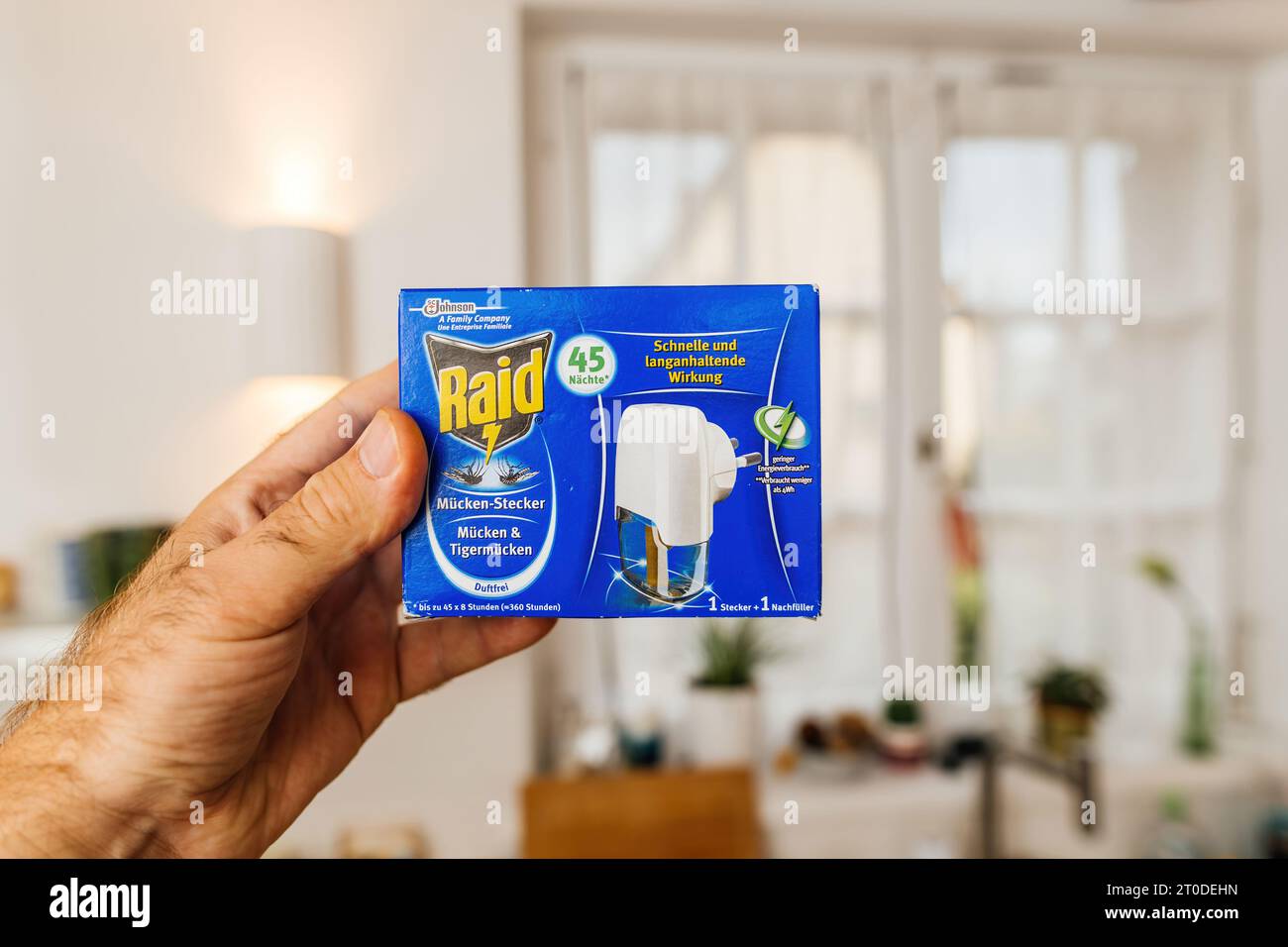 Blue Raid Paris, France - Aug 4, 2023: A male hand holding Raid mosquito ...
