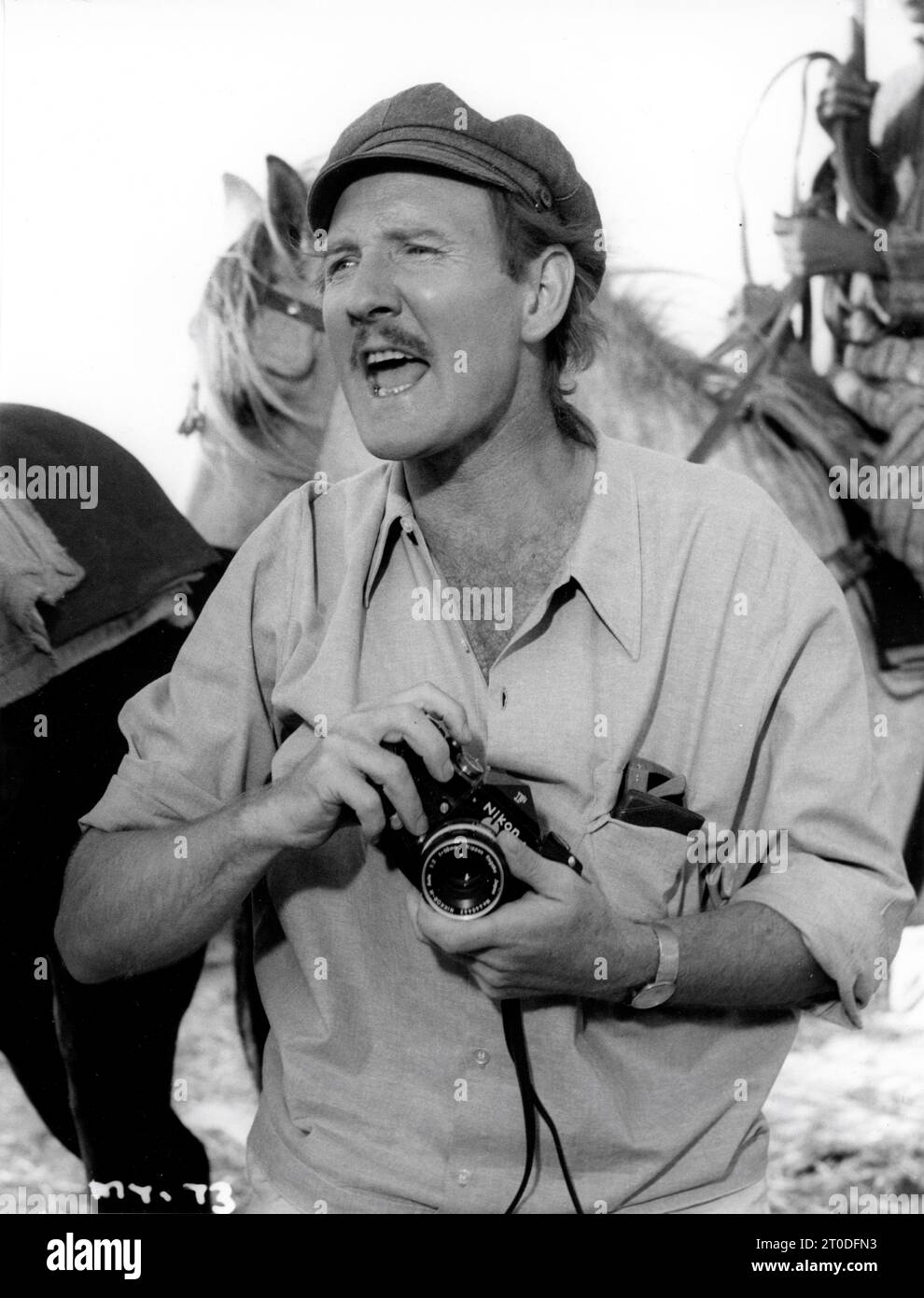 LESLIE PHILLIPS as a professional photographer doing photo session with a Nikon still camera in MAROC 7 1967 director GERRY O'HARA writer David Osborn producers John Gale and Leslie Phillips executive producer Martin Schute Cyclone / Rank Film Distributors Stock Photo