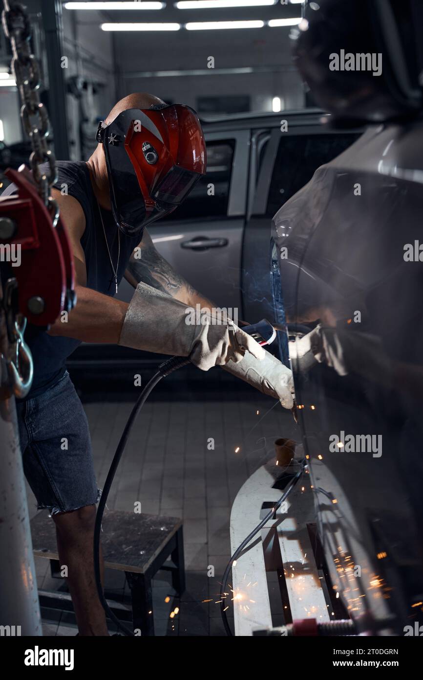 Automechanic welding car, changing rusted and rotten places Stock