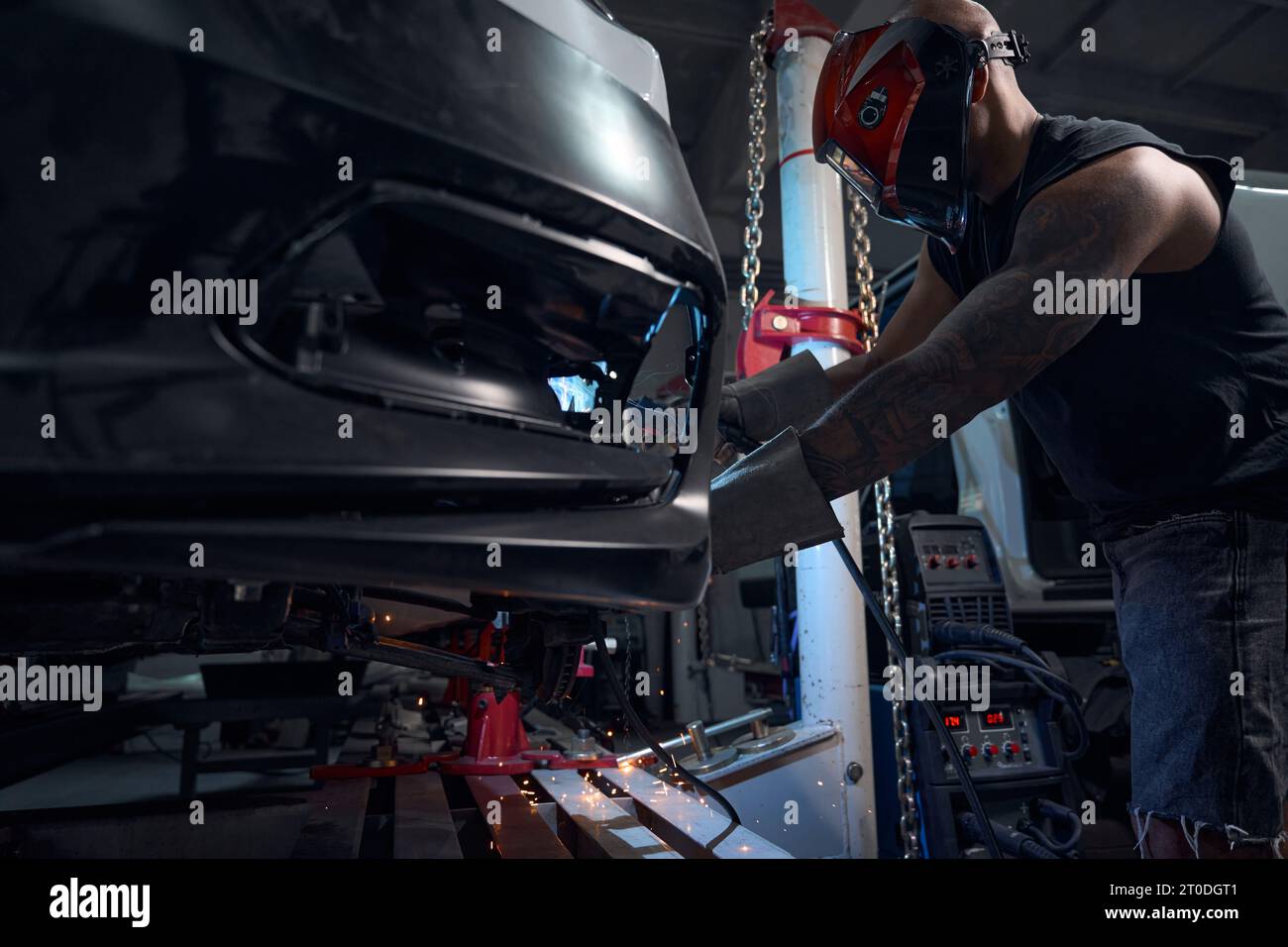 Automechanic welding rusted and rotten car sills and fenders Stock