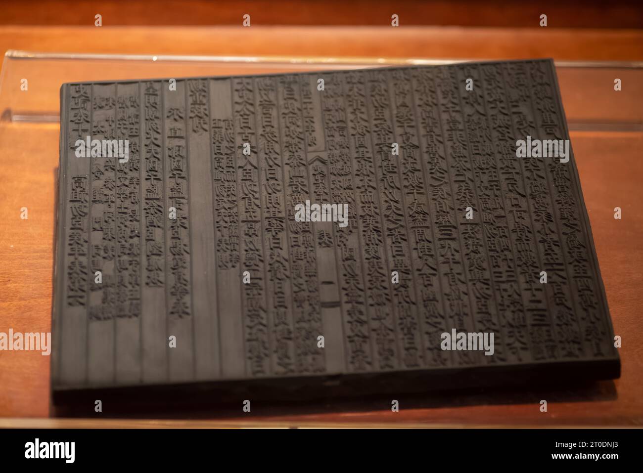 Ancient Chinese woodblock printing board, ancestor of printing press technique from China,shot at China engraving printing museum. Stock Photo