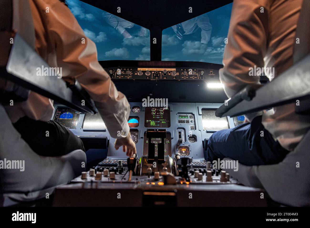 pilots in a cockpit in an airplane during flight Stock Photo