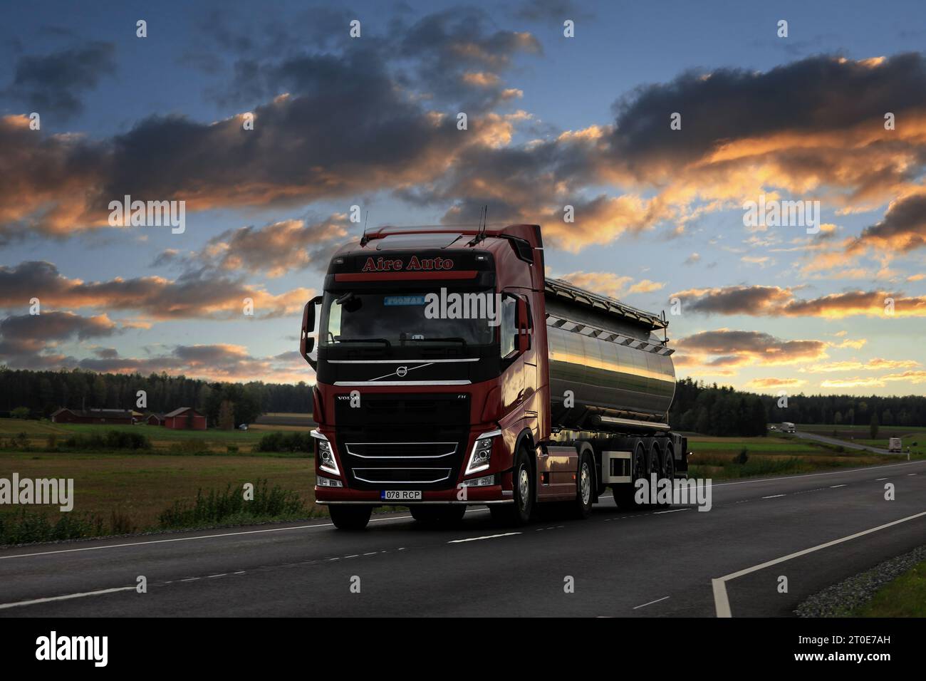 Red Volvo FH truck Aire Auto pulls tank semi-trailer on highway 10 in evening light. Koski TL, Finland. September 21, 2023. Stock Photo