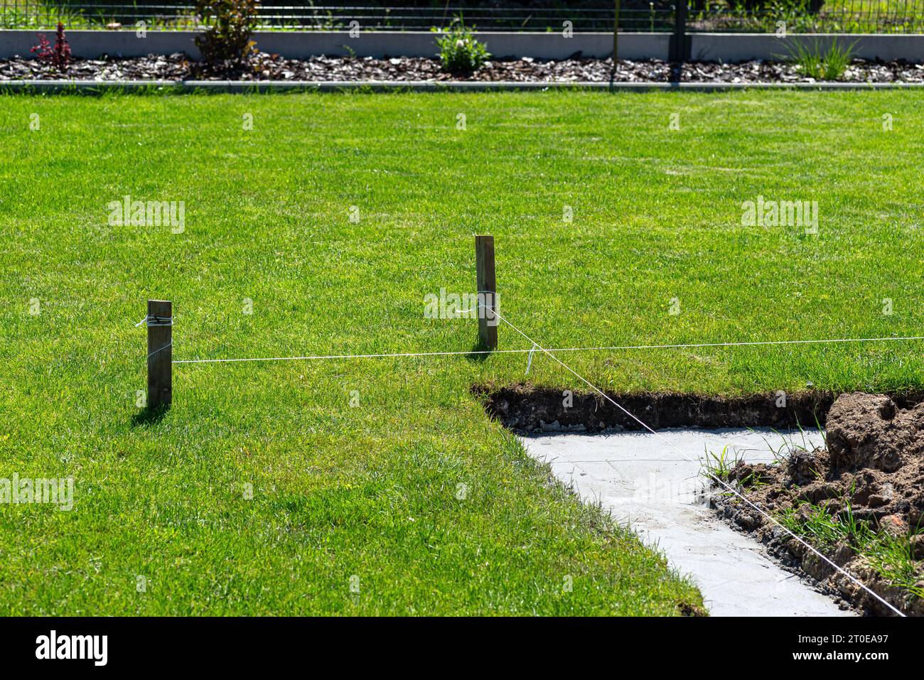 Foundation footings poured in a ditch in the yard, building a terrace in the backyard. Stock Photo