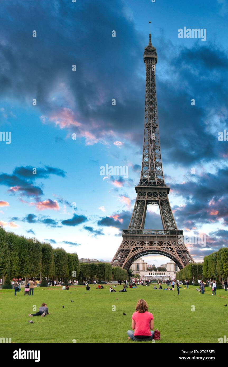 Paris 7th arrondissement. The Champ de Mars with tourists at the foot of Eiffel tower. Paris Ile de France. France Stock Photo