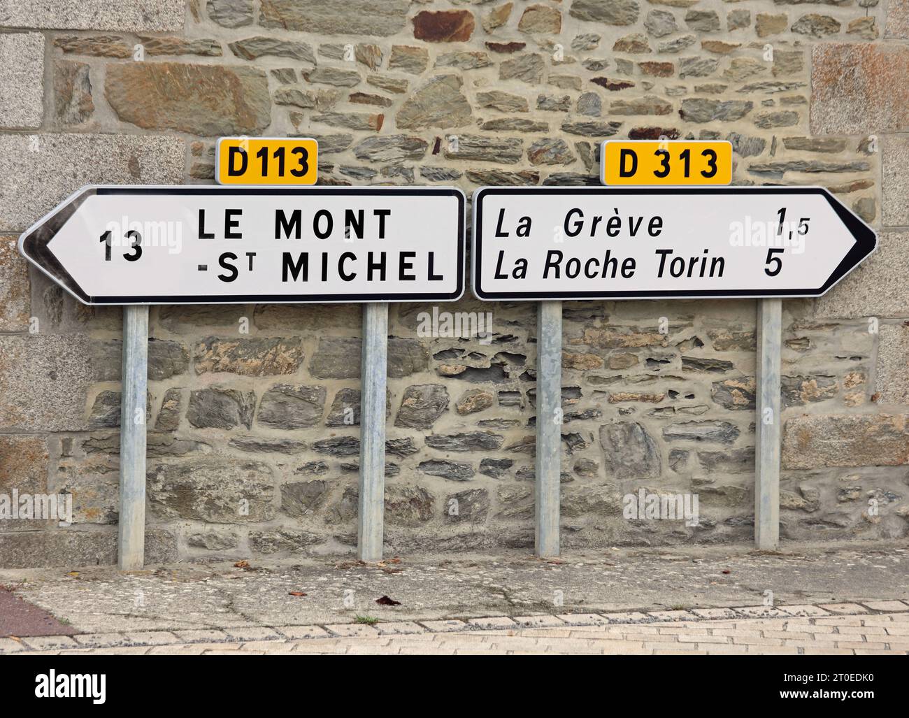 road signs with directions to Mont Saint Michel at 13 km and other