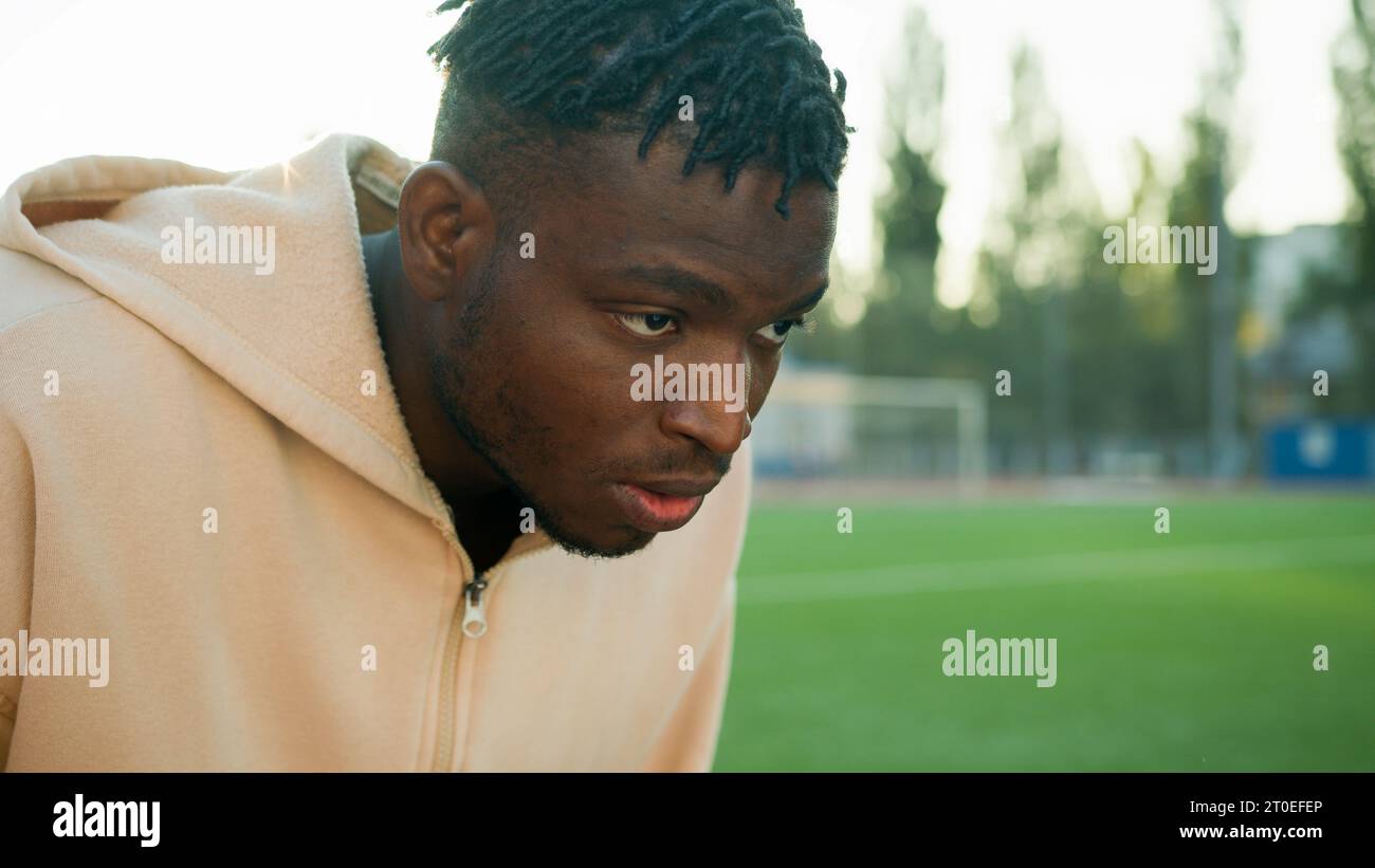 African American sport man athlete in low start position getting ready ...