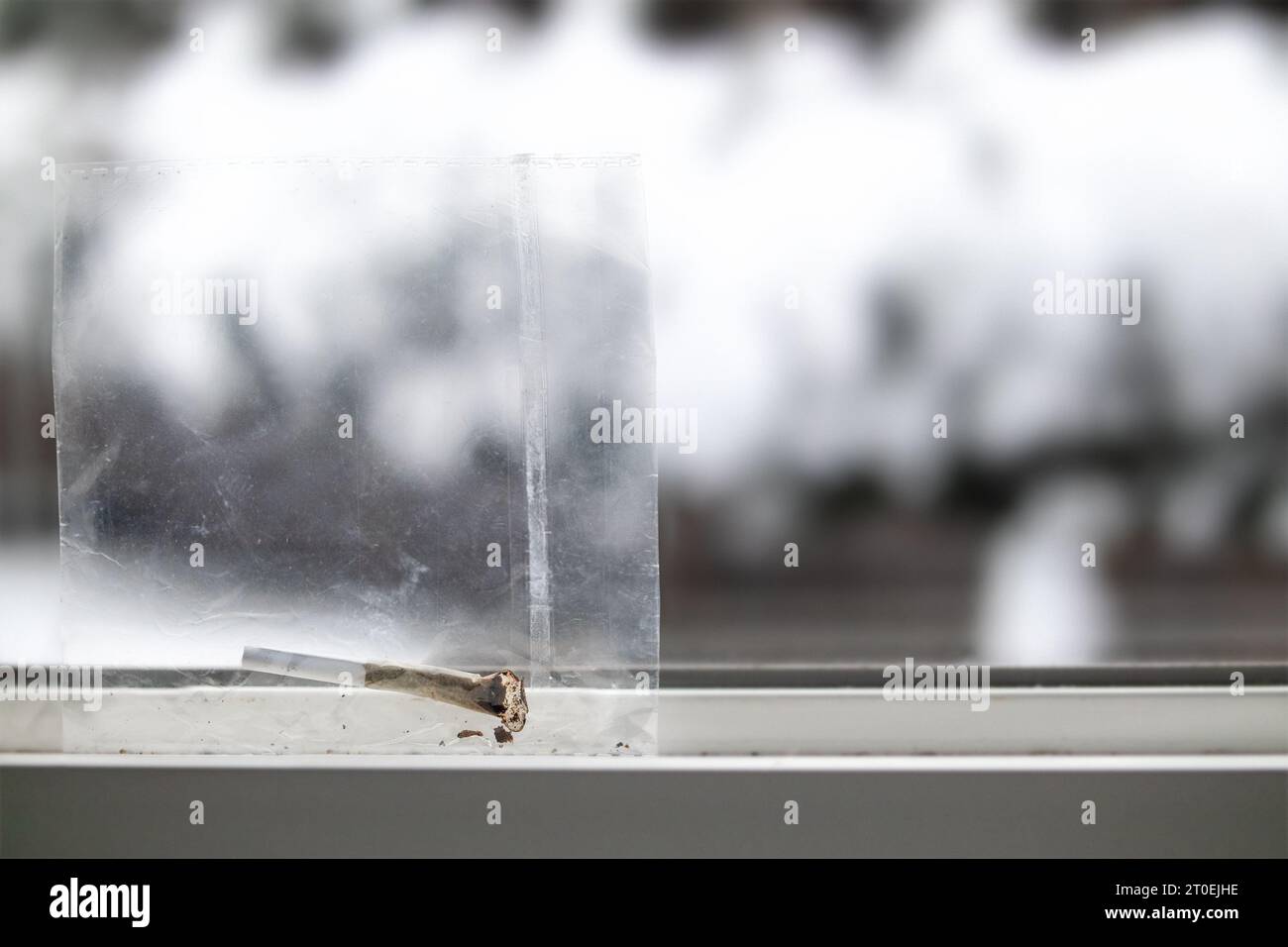 Used cannabis joint in plastic bag finish later, placed by a window