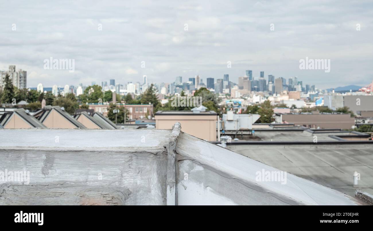 Close up hvac unit on flat roof with downtown skyline. Rooftop makeup