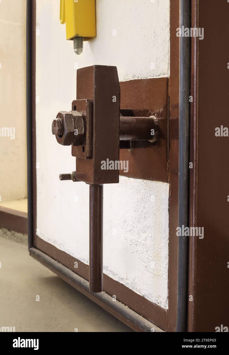 Blast door lock mechanism in building bomb shelter in Switzerland. Massive heavy duty air-lock on concrete door in fallout shelter or survival bunker Stock Photo