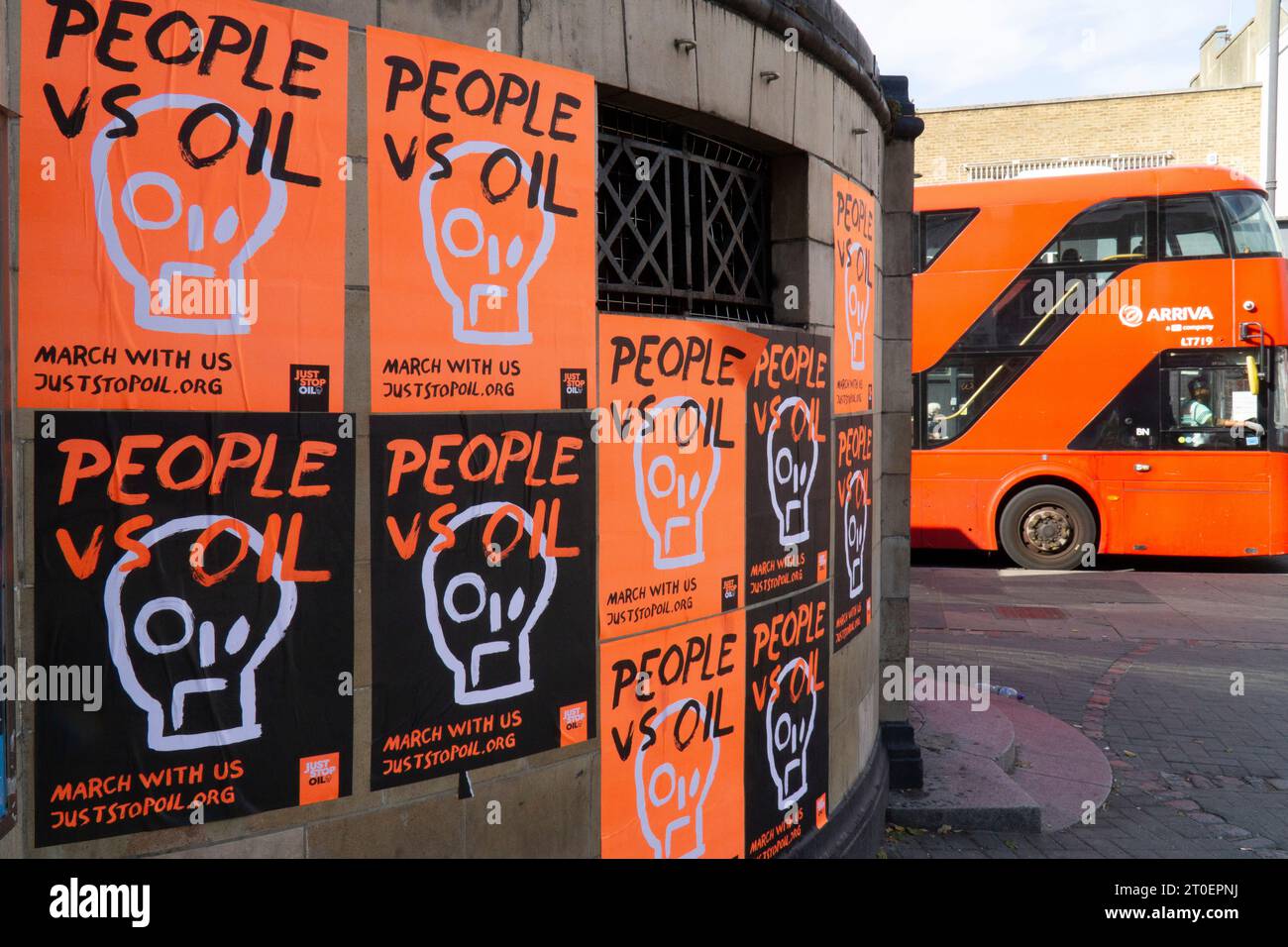 London, UK. 6th Oct, 2023. bright orange and black posters with the slogan 'People vs oil' have been plastered on the exterior of Clapham Common tube station by environmental campaign group Just Stop Oil. The group are planning a series of peaceful protests from 29 October onwards. Credit: Anna Watson/Alamy Live News Stock Photo