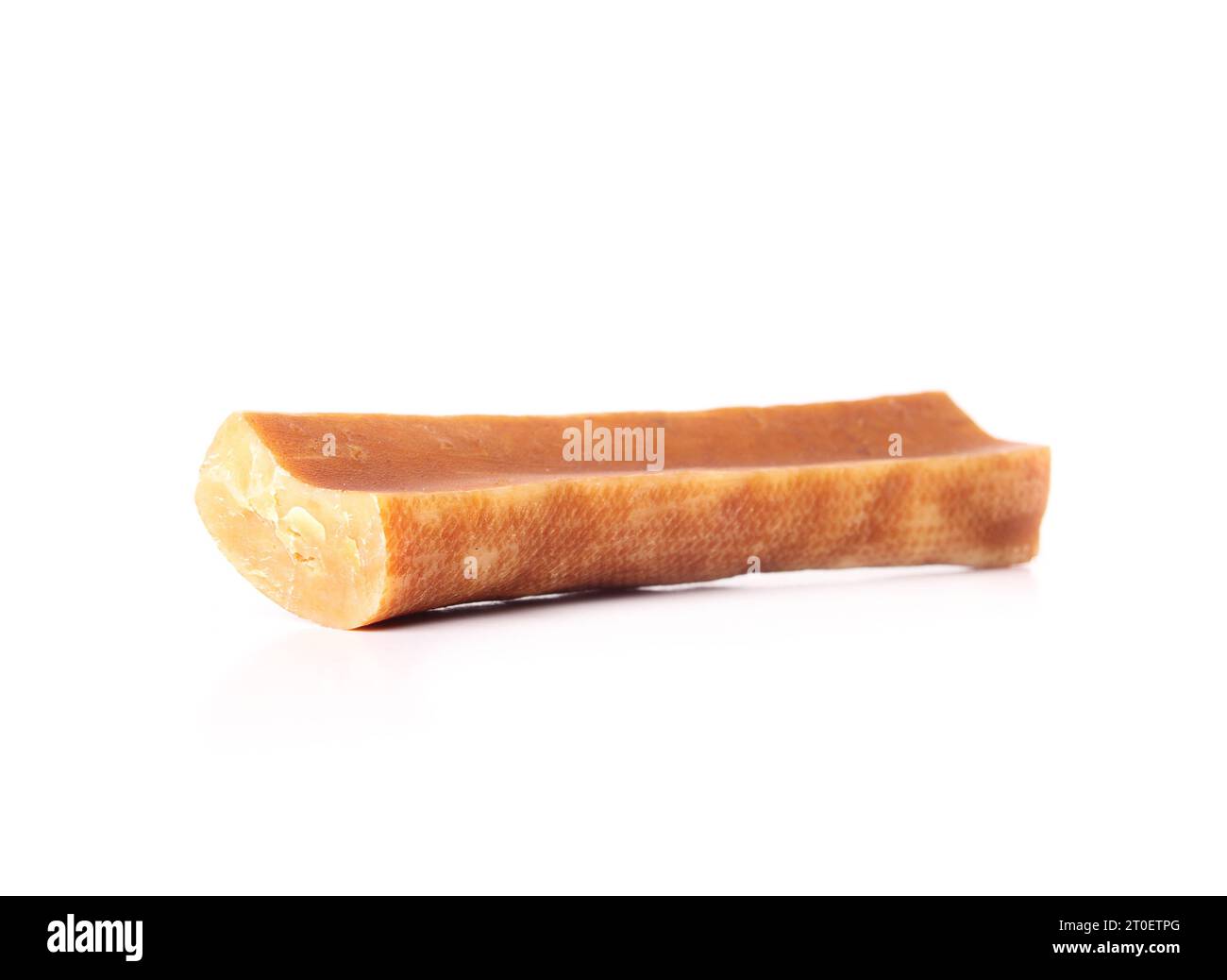 Isolated Yak cheese dog chew bone. Sideview of yellow orange dog chew