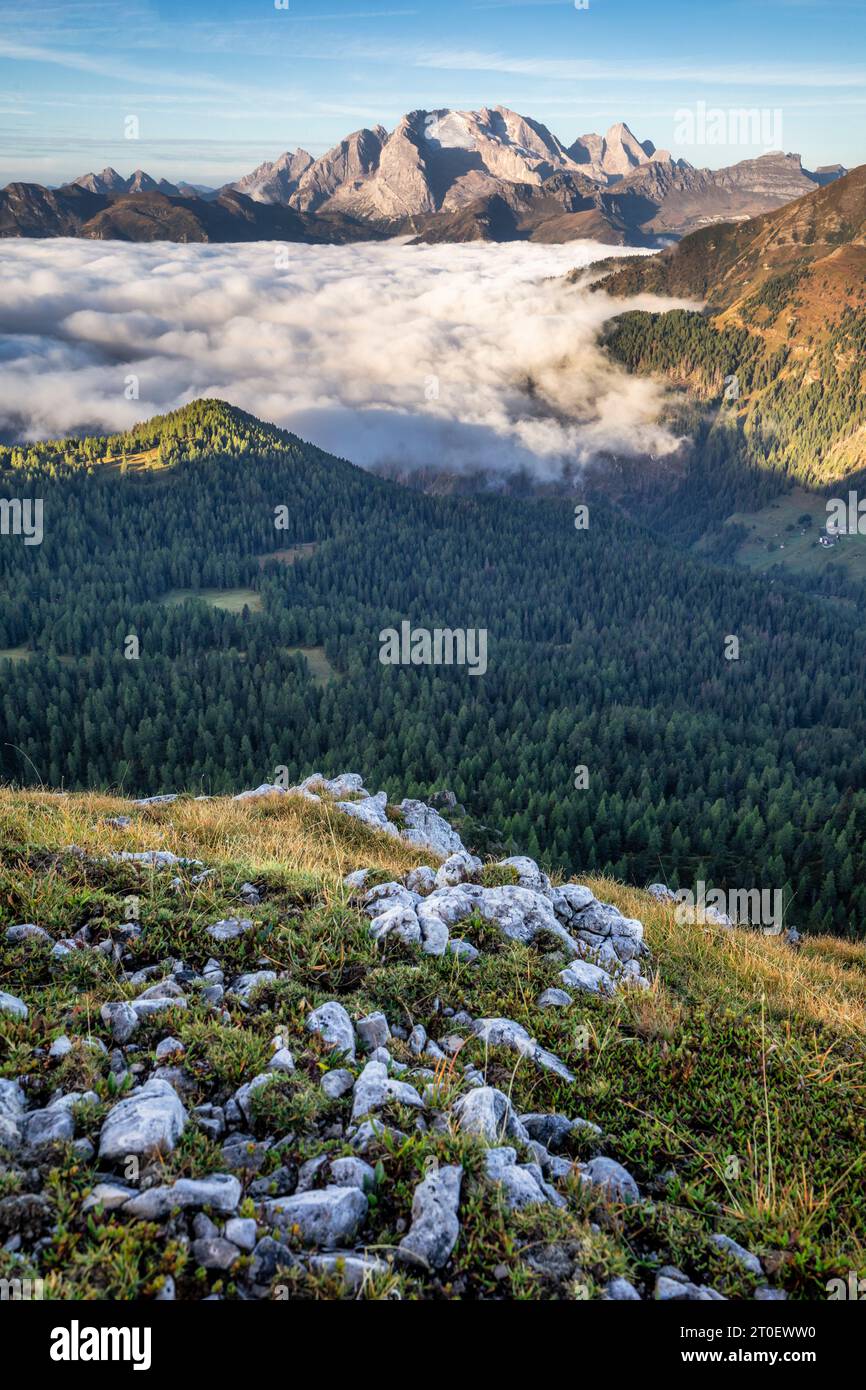 Italy, Veneto, province of Belluno, view from above towards the Padon ridge and Marmolada, below in the valley a carpet of clouds, Dolomites Stock Photo