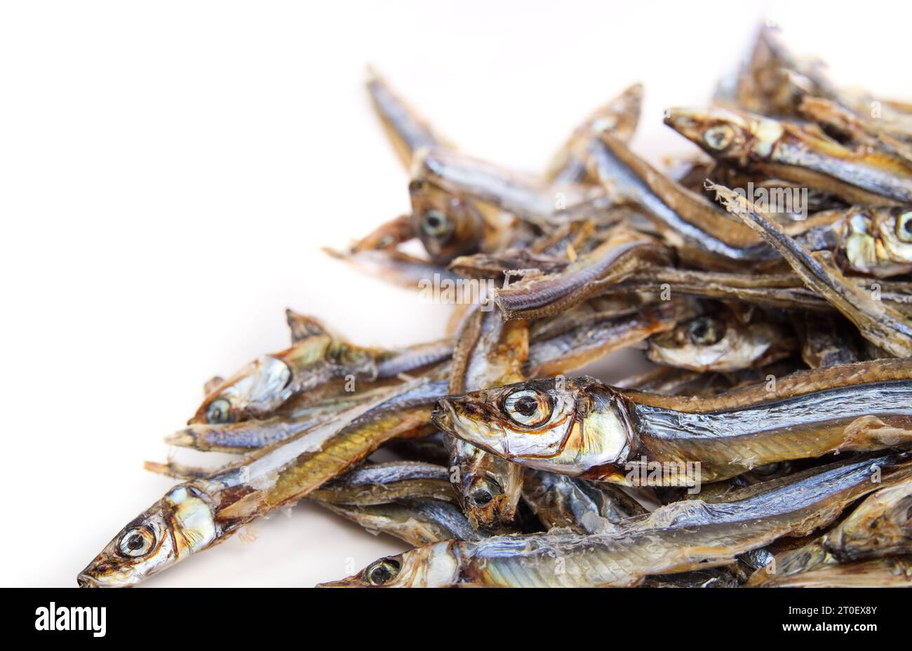 Pile of dried sardines for dogs and cats for treats. Many dehydrated fishes in multiple sizes. Healthy dog snack or health supplement rich on protein, Stock Photo