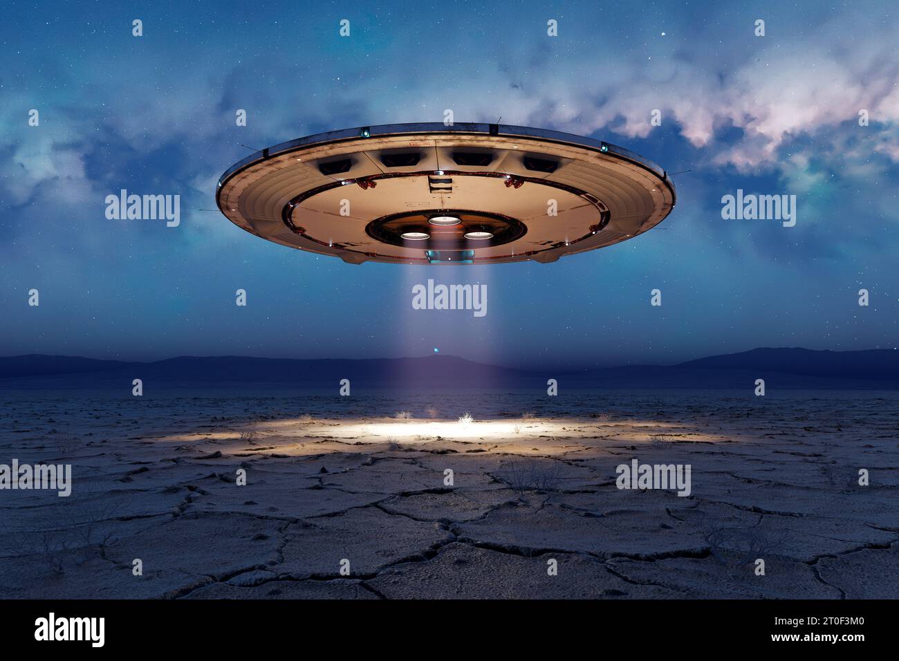 Alien invasion Circular silhouette of the shiny metal flying saucer over the empty desert at night. UFO, UAP, hangs above the ground and shoots a brig Stock Photo