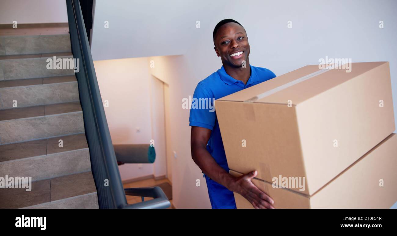 Movers Carrying Boxes On Residential Well Well Stairs Stock Photo