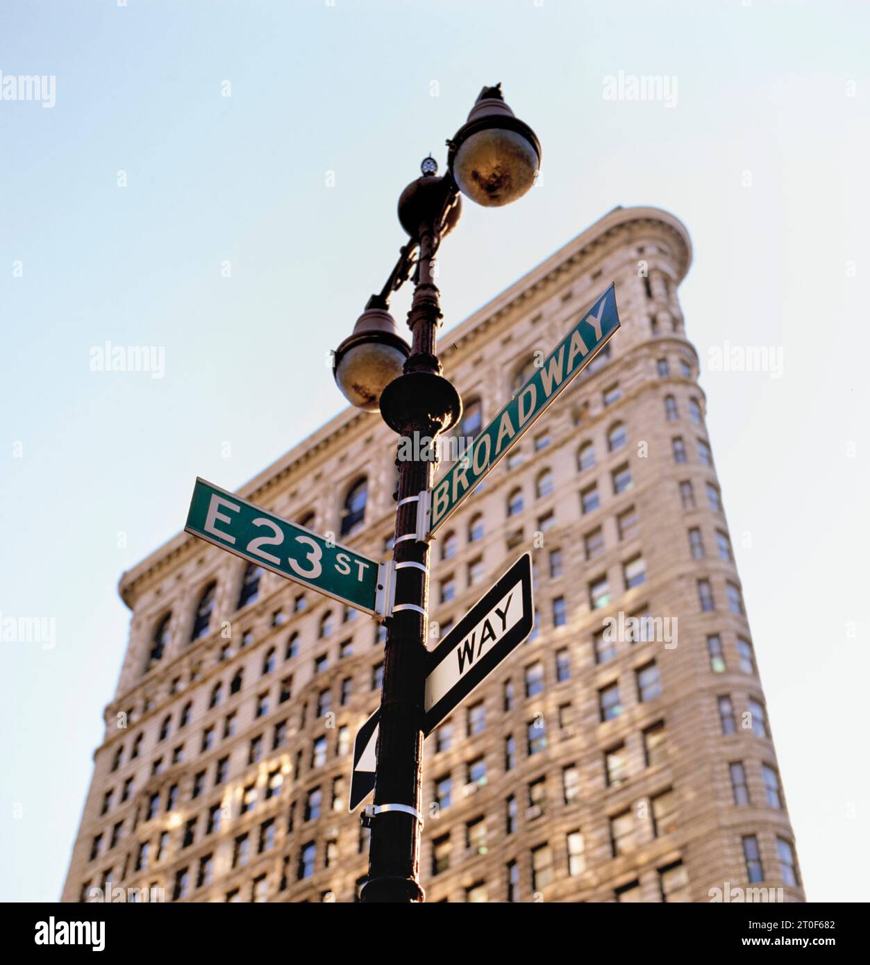 Flat Iron building stone and steel structure with street sign Broadway. Stock Photo