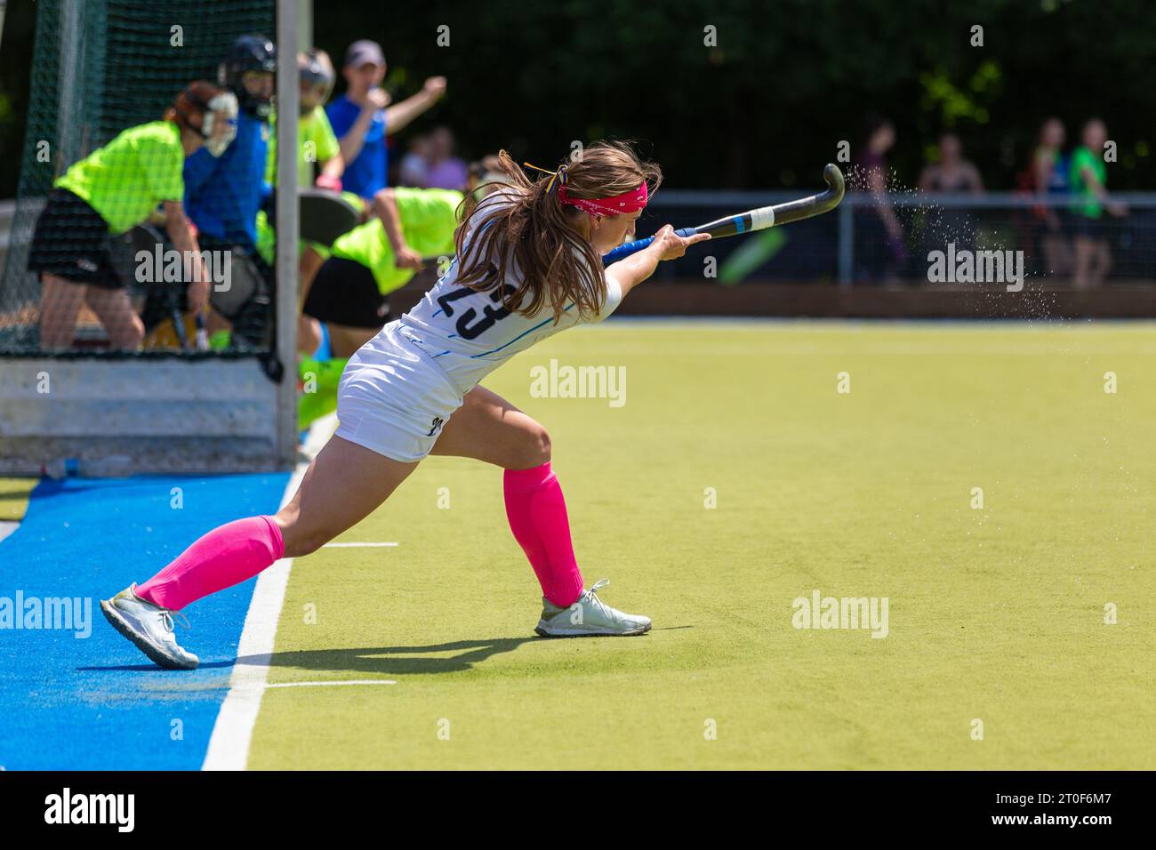 Young female field hockey player performing short corner Stock Photo
