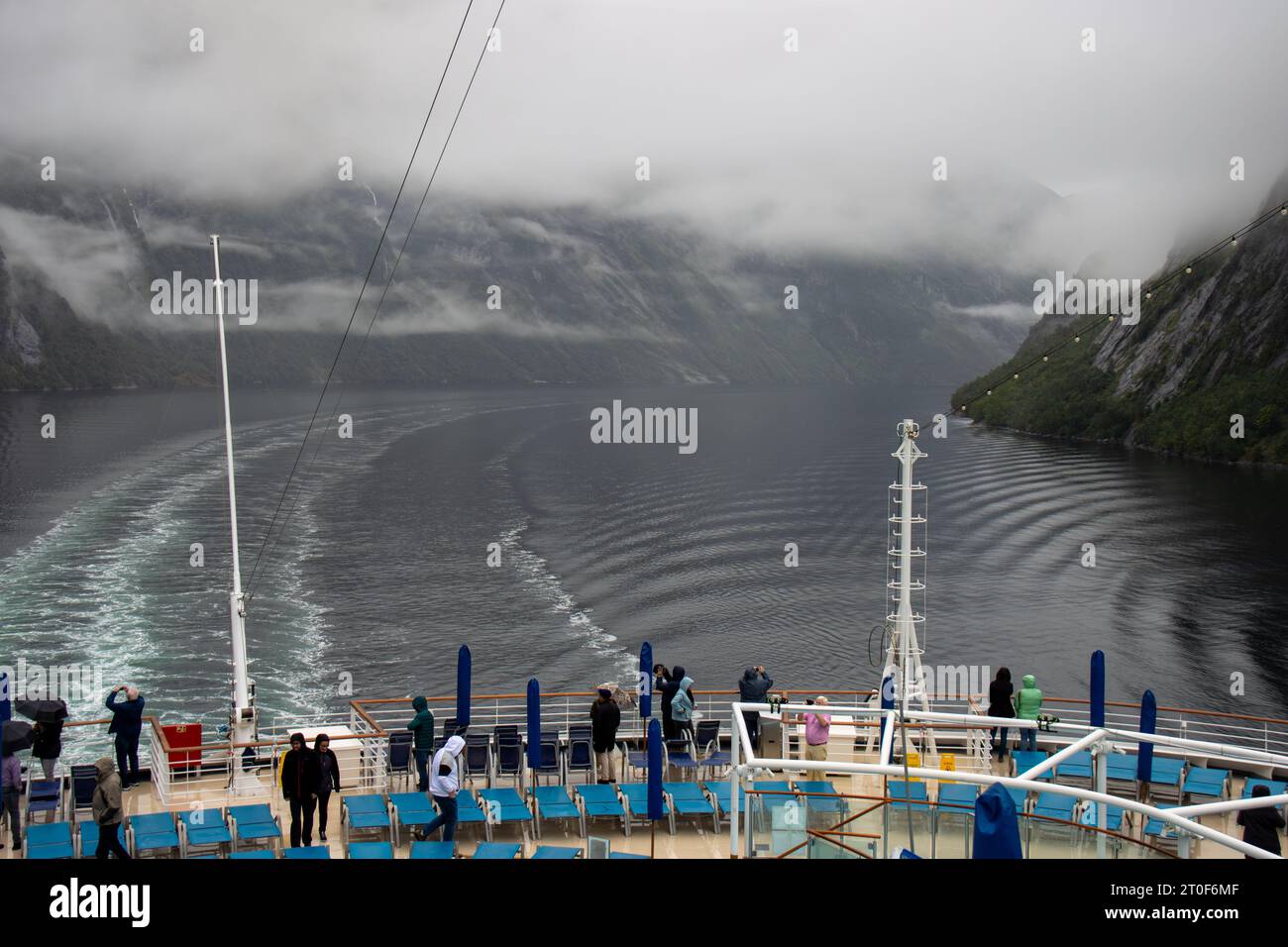 Fiordo de Geiranger envuelto en niebla. Personas de un crucero disfrutando y tomando fotografías, Noruega Stock Photo