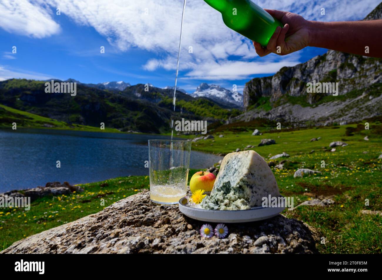Pouring in glass of natural Asturian cider made from fermented apples