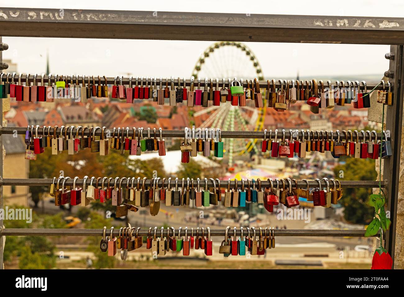 love locks at the Petersberg hill in Erfurt with view over the cathedral square in the background Stock Photo