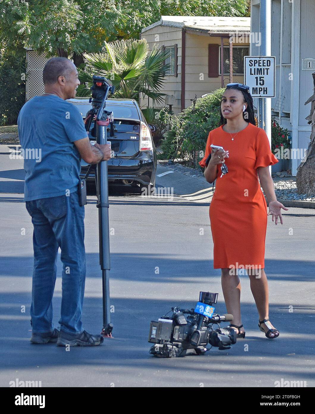 local news television cameraman and a  reporter  cover a crime scene in Union City, California, on the morning of October 5, 2023 Stock Photo